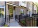 Charming brick townhome entrance with black iron fencing and landscaped yard at 606 Goldsmith Ct # 114, Johns Creek, GA 30022