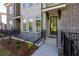 Charming brick townhome entrance with black iron fencing at 606 Goldsmith Ct # 114, Johns Creek, GA 30022
