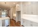 Gourmet kitchen featuring stainless dishwasher and neutral colored cabinetry with under cabinet lighting at 606 Goldsmith Ct # 114, Johns Creek, GA 30022
