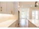 Contemporary kitchen with white countertops, tiled backsplash and view to the living room at 606 Goldsmith Ct # 114, Johns Creek, GA 30022