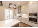 Well-equipped kitchen features an island, stainless steel appliances, quartz countertop and modern lighting at 606 Goldsmith Ct # 114, Johns Creek, GA 30022