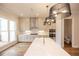 Open kitchen with central island, white countertops and view to the breakfast room at 606 Goldsmith Ct # 114, Johns Creek, GA 30022