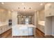 Open kitchen boasts center island, stainless appliances, and neutral cabinetry at 606 Goldsmith Ct # 114, Johns Creek, GA 30022