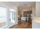 Bright kitchen with quartz countertops, stainless steel appliances, hardwood floors, and access to the porch at 606 Goldsmith Ct # 114, Johns Creek, GA 30022