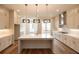 Modern kitchen features white cabinets, stainless steel appliances, kitchen island and pendant lighting at 606 Goldsmith Ct # 114, Johns Creek, GA 30022