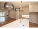 Bright open kitchen with quartz counters, island sink, modern appliances, pendant lighting, and hardwood floors at 606 Goldsmith Ct # 114, Johns Creek, GA 30022