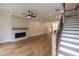 Open living room boasts hardwood floors, modern fireplace, and staircase to the second floor at 606 Goldsmith Ct # 114, Johns Creek, GA 30022
