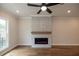 Living room featuring a modern fireplace, hardwood floors and great light from a large window at 606 Goldsmith Ct # 114, Johns Creek, GA 30022
