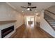 Spacious living area with hardwood floors, fireplace, ceiling fan, and open view to the kitchen at 606 Goldsmith Ct # 114, Johns Creek, GA 30022