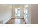 Empty room with large window, hardwood floors, white trim, and access to porch at 606 Goldsmith Ct # 114, Johns Creek, GA 30022