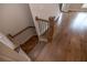 Elegant staircase with hardwood floors and wrought iron spindles leads to the upper level at 606 Goldsmith Ct # 114, Johns Creek, GA 30022
