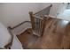 Staircase with hardwood floors, black metal railings, and natural wood handrail at 606 Goldsmith Ct # 114, Johns Creek, GA 30022