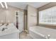 Bathroom with double sink vanity, soaking tub and glass door shower at 7550 Springmill Ct, Cumming, GA 30028