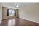 Large bedroom with hardwood floors, a ceiling fan, and a bright window at 7550 Springmill Ct, Cumming, GA 30028