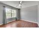 Bright bedroom with hardwood floors, large windows and neutral walls at 7550 Springmill Ct, Cumming, GA 30028