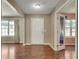 Welcoming entryway with wood floors, a white front door, and a view into an adjacent room at 7550 Springmill Ct, Cumming, GA 30028