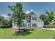 Well-maintained two-story home with vinyl siding, a stone entryway, and a lush green lawn at 7550 Springmill Ct, Cumming, GA 30028