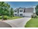 Traditional two-story home with a manicured lawn, long driveway and attached garage at 7550 Springmill Ct, Cumming, GA 30028