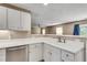 Bright kitchen featuring white cabinets and tile flooring at 7550 Springmill Ct, Cumming, GA 30028