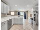 Bright kitchen with white cabinets, stainless steel appliances, and tile flooring at 7550 Springmill Ct, Cumming, GA 30028