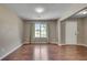 Spacious living room featuring hardwood floors, neutral paint, and a bright window at 7550 Springmill Ct, Cumming, GA 30028