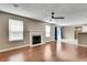 Open-concept living room with fireplace, windows and patio doors at 7550 Springmill Ct, Cumming, GA 30028