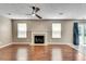 Open living room with hardwood flooring, fireplace, and ample natural light at 7550 Springmill Ct, Cumming, GA 30028