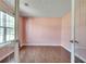 Versatile room with hardwood floors, neutral walls, and a window providing natural light at 7550 Springmill Ct, Cumming, GA 30028