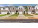 Charming townhouse exterior with brick accents, attached garage, and well-manicured lawns at 357 Navigator Ln, Mcdonough, GA 30253