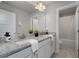 Bright bathroom with double vanity featuring granite countertop and white cabinets at 197 Stafford Ln, Villa Rica, GA 30180