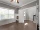 A room with hardwood floors, large windows, and neutral gray walls, leading to a small attached area at 197 Stafford Ln, Villa Rica, GA 30180