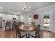 Open concept dining room with a modern chandelier, wood table, and access to the kitchen at 197 Stafford Ln, Villa Rica, GA 30180