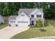 Charming two-story home with a well-manicured lawn, three-car garage, and a classic American aesthetic at 197 Stafford Ln, Villa Rica, GA 30180