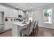 Bright kitchen with white cabinetry, stainless appliances, breakfast bar, and natural light from the adjacent window at 197 Stafford Ln, Villa Rica, GA 30180