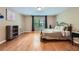 Spacious bedroom with hardwood floors, a large window, and neutral paint at 1025 Ector Nw Dr, Kennesaw, GA 30152