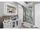 This remodeled bathroom features a glass shower, modern vanity, and updated fixtures at 1146 Simonton Peak Way, Lawrenceville, GA 30045