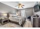 This bedroom features modern furniture, a ceiling fan, and a large window at 1146 Simonton Peak Way, Lawrenceville, GA 30045