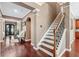 Inviting foyer with staircase, elegant hardwood floors, and tasteful decor at 1146 Simonton Peak Way, Lawrenceville, GA 30045