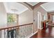 Elegant upstairs hallway features beautiful hardwood flooring and a chandelier at 1146 Simonton Peak Way, Lawrenceville, GA 30045