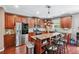 Charming kitchen features wooden cabinetry, stainless steel appliances, granite countertops, and a kitchen island at 1146 Simonton Peak Way, Lawrenceville, GA 30045