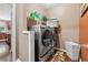 Functional laundry room with modern washer and dryer, built-in shelving, and stylish decor at 1146 Simonton Peak Way, Lawrenceville, GA 30045