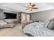 This spacious main bedroom features a tray ceiling, ceiling fan, and a TV at 1146 Simonton Peak Way, Lawrenceville, GA 30045