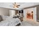 This spacious main bedroom features a tray ceiling, ceiling fan, and an ensuite bathroom at 1146 Simonton Peak Way, Lawrenceville, GA 30045