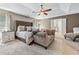 This spacious main bedroom features a ceiling fan, sitting area, and ensuite bathroom at 1146 Simonton Peak Way, Lawrenceville, GA 30045
