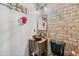 Chic powder room featuring a unique vessel sink, brick accent wall, and modern fixtures at 1146 Simonton Peak Way, Lawrenceville, GA 30045