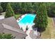 Aerial view of a pristine community pool featuring ample seating and mature trees at 1146 Simonton Peak Way, Lawrenceville, GA 30045