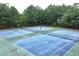 Well-maintained tennis courts surrounded by lush greenery, perfect for recreational activities at 1146 Simonton Peak Way, Lawrenceville, GA 30045