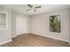 Comfortable bedroom with a ceiling fan, closet, and large window offering natural light at 336 Rockmoor Trl, Marietta, GA 30066