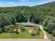 A sprawling single-story home with a lush green lawn and mature trees is a must see at 1725 Mountainside Dr, Cumming, GA 30040