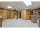 A finished basement features stairs, a kitchen, and wood paneling throughout at 1725 Mountainside Dr, Cumming, GA 30040